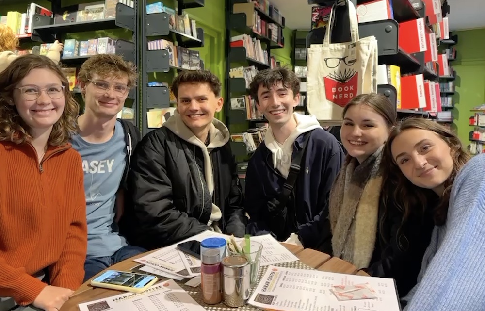 91̽ student Peter and a group of friends in a Brussels cafe